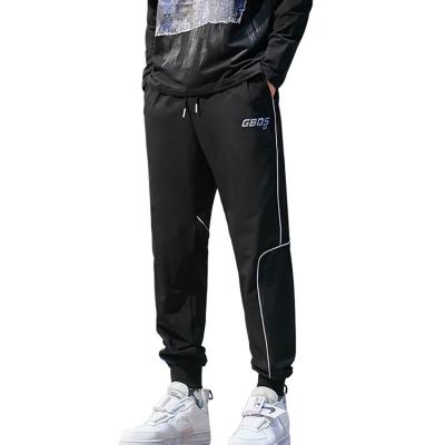 China Anti-wrinkle sports pants men spring casual pants new colorful reflective printed pants for sale