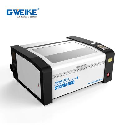 China Automatically Hobby Use Home Use CO2 Laser Cutting Machine Storm600 Mini Laser Cutter for sale