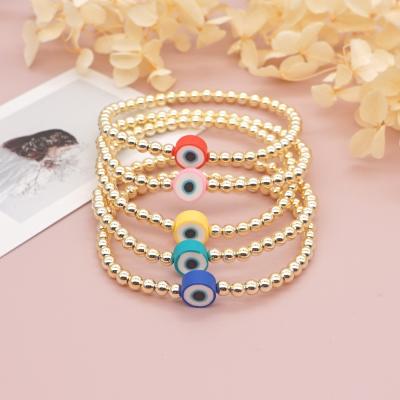 China Fashion Cute Gold Beaded Elastic Bracelets Jewelry Cute Colorful Blue Eyes Charm Bracelet For Women Girls for sale