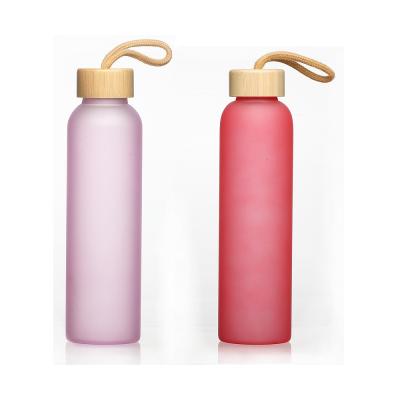 China Sustainable 550ml Colored Spray Paint Frosted Sport Glass Water Bottle With Bamboo Lid for sale