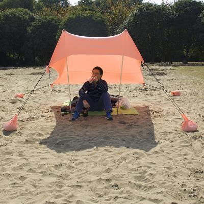 China Customized Portable UV50 UV-Resistant Protect Stretch Beach Shelter Tent Sunshade With Sand Anchor Bag for sale