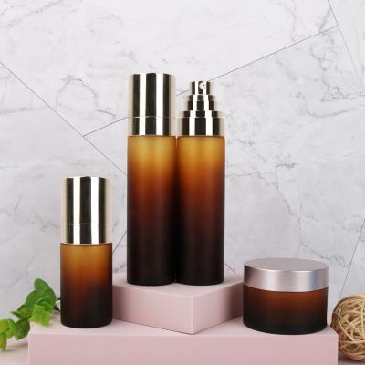 China Custom 50ml 80ml 100ml 120ml Household Products Electroplate Gold Pump Frosted Amber Cosmetics gtadient Spray Serum Bottle Jar and Bottle Set for sale