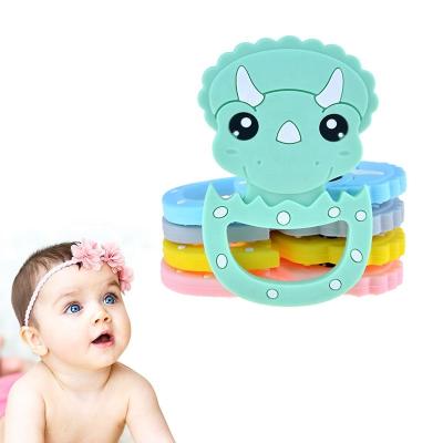 China Amazon Food Grade Silicone Cartoon Triangle Battery Operated Dragon Teething Toys For Teeth Rod Baby Teethers Gift Tiny for sale