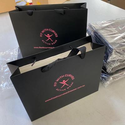 China Wholesale Custom Recycled Materials Christmas Gift Bags With Logo Shopping Bag Hard Paper Bag for sale