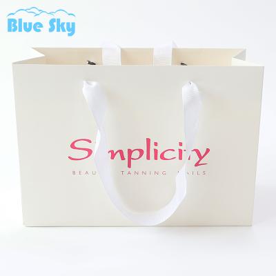 China China Wholesaler Free Sample Biodegradable Logo Carrier White Paper Carrier Beauty Instrument Custom Apparel Gift Bag for sale