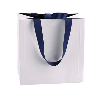 China Handmade Custom Logo Embossing Eco - Friendly Kraft Paper Boutique Shopping Bags for sale