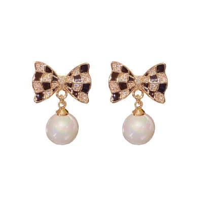 China New Tide S925 Fashionable Silver Bow Silvery Black And White Checkered Pearl Needle Artistic Creative Earrings Retro for sale