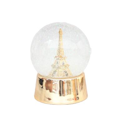 China Christamas Home Decoration Promotion Gifts Resin Pyramid Water Polo With Bottom Eiffel Tower Crystal Ball Scene Gold Decoration For Travel Souvenir for sale