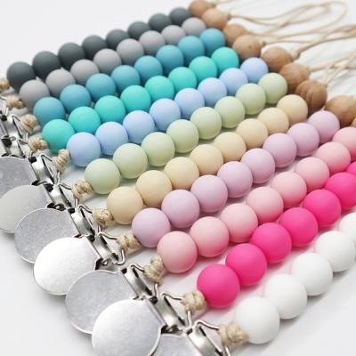 China 100%food grade BPA free silicone custom silicone newborn teether wooden beads pacifier clips with silicone metal wooden clips for sale