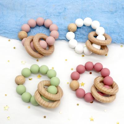 Китай BPA Free Eco-Friendly Baby Teether Healthy Wooden Silicone Bead Teethers Personalized Custom Teething Bracelet Rattle Ring Wholesale продается