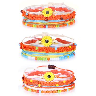 China Hot-selling Cute Jewelry Alloy Oil Drip Daisy Bracelet Wax Thread Waterproof Rice Beads Handwoven Creative Bracelet Set for sale