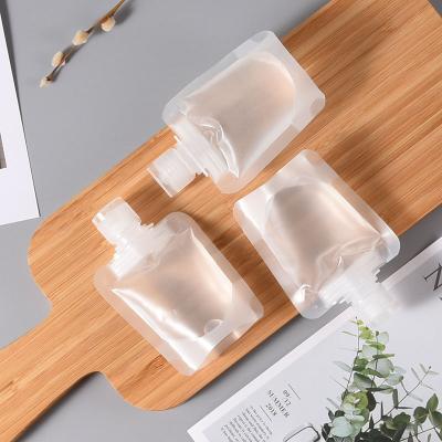 China Hot Sale 30ml 50ml 100ml Matte Transparent Stand Up Plastic Barrier Liquid Spout Pouch For Shampoo Cosmetic Flip Top Spout Pouch for sale