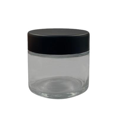 China Factory direct wholesale custom clear glass 2oz jar cosmetic with black CR lid for cosmetic paste storage for sale