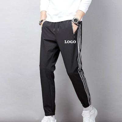 China Customized casual pants men's anti-pilling logo spring and summer Korean sports new fashion youth link sweatpants nylon ice silk long pants for sale