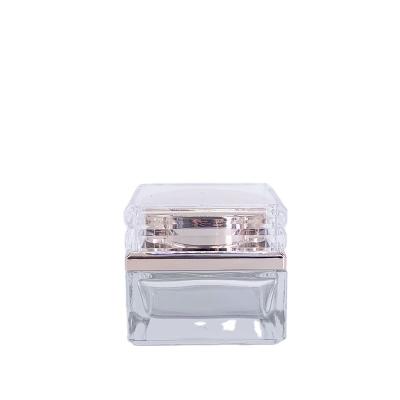 China Luxury Cosmetic Glass Jar Luxury Cosmetic Container 50g Square Gold Face Cream Personal Care Jar Bottle for sale