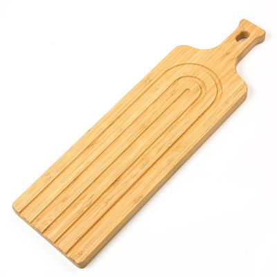 China Viable Classic Design Long Strip Bamboo Bread Cheese Cutting Boards With Handle Serving Paddle Pizza Boards Plate With Drip Groove for sale