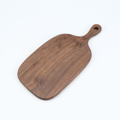 China Durable Black Walnut Kitchen Bread Pizza Steak Serving Wooden Cutting Board Irregular Serving Tray Durable Board with Handle for sale