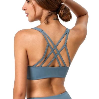 China Breathable ODM Soft Stretch Compression Yoga Shoulder Sports Bra Supportive Cross Sports Bra For Women Fitness for sale