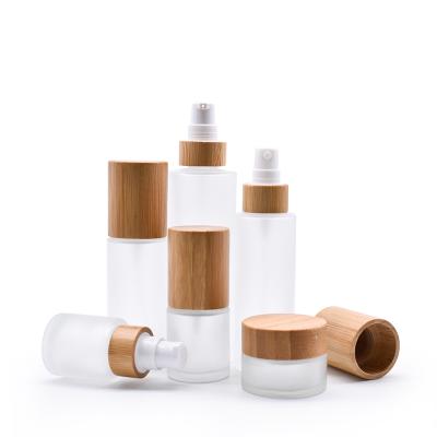 China High End Custom Logo Body Lotion Bamboo Cap Custom Logo Frosted Glass Cosmetic Cover Spray Bottle for sale