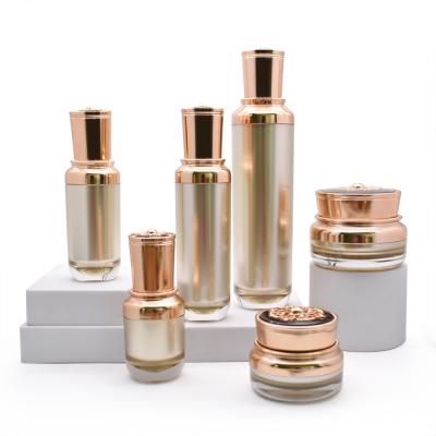 China Cosmetic Luxury Cosmetic Packaging Set Gold Color Acrylic Bottles And Jars With Lids for sale