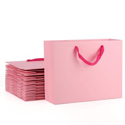 China Custom Logo Printed Pink Paper Gift Recyclable Wholesale Bags for sale