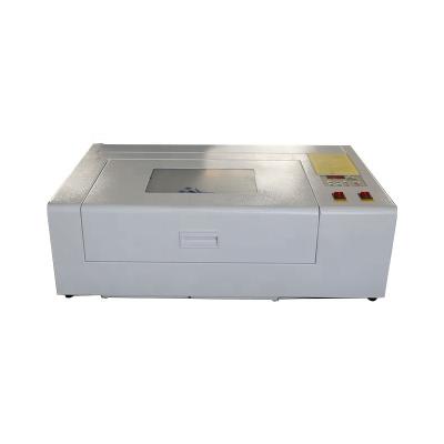 China Fire LGA-3020 CO2 40W 50w Small Laser Engraver Cutter Laser Water Cooled Green Desktop Engraving Machine for sale