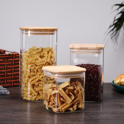 China Custom Square Glass Freshness Storage Jar Borosilicate Glass Spice Jar With Wooden Lid for sale