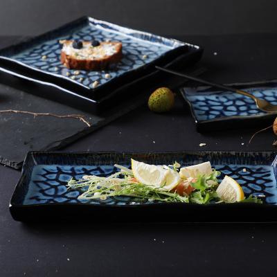 China Sustainable Wholesale Square Ceramic Dinner Plate Sets Glazed Blue Embossment Plates Flammed for sale