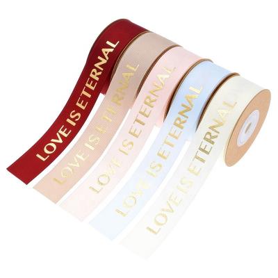 China Beautiful LOVE is OEM Artwork Eternal Custom Logo 25mm Gold Foil Printed 3D Grosgrain Ribbon for Valentine's Day Ribbon with Flowers for sale