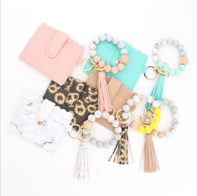 China Wholesale Waterproof Food Grade Silicone Bead Bracelet Key Chain PU Card Wallet Wristlet Bracelet Key Chain With Tassel for sale