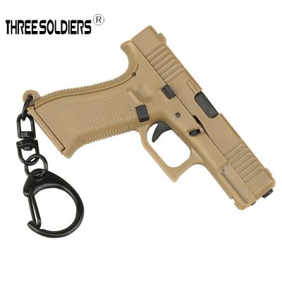 China Creative Gun Model Pendant Mini Key Chain Decoration Personality Buckle Backpack Zipper Home Decorative Ignition Buckle for sale