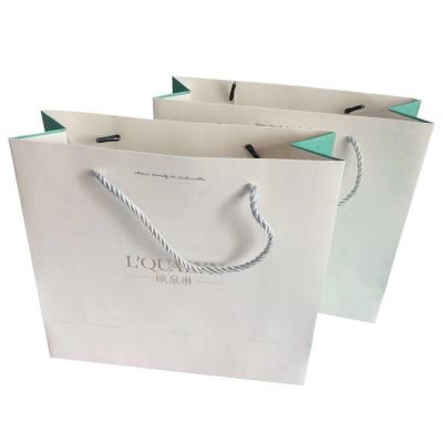 China Recyclable Luxury boutique gift shoes t- shirt clothes clothing packaging ivory paper shopping bags with ribbon handle for sale