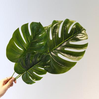 China Large Contemporary Tropical Green Artificial Areca Palm Leaves Monstera Deliciosa Plant Table Decoration Jungle Beach Theme Party for sale