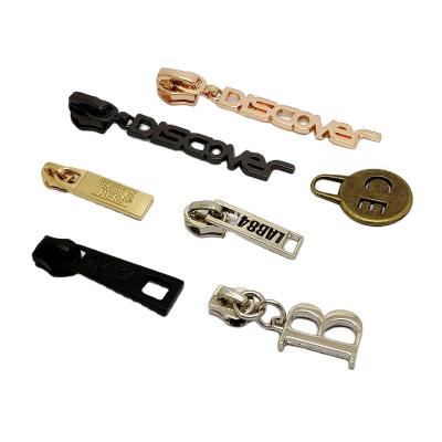 China Nickel Free Plating Metal Decoration Customized Zinc Alloy Engraved Zipper Puller From China for sale