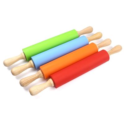 China Sustainable Baking Tools Utensils Cookie Dough Noodle Silicone Rolling Pin With Wooden Handle for sale