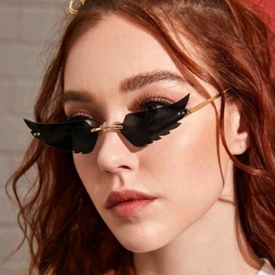 China Fashion Sunglasses Wing Shaped Rimless Sunglasses For Women Men for sale