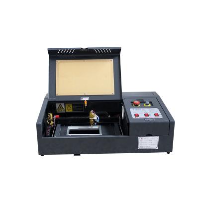 China 3020 Acrylic Rubber Laser Engraving Cutter CO2 Acrylic Self Inking Stamp Laser Engraving Machine for sale