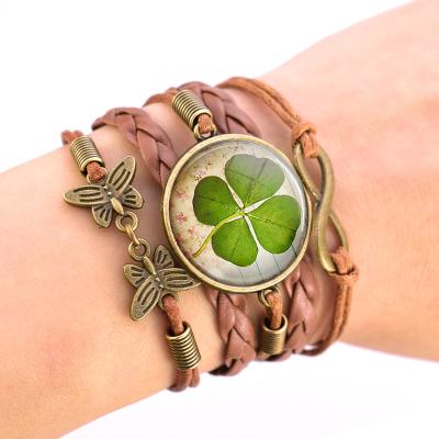 China CLASSIC Four Leaf Clover Bracelet Clover Pattern Handmade Glass Cabochon Silver Metal Bracelet Weave Leather Jewelry Friends Gift for sale