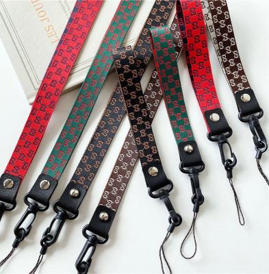 China Lanyard Length Mobile Phone Shell Nylon Cell Phone Shell Hanging Key Tide Brand Wrist Rope Hanging Key Chain PEND for sale