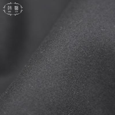 China DIMENSIONAL black wool thick skirt suit fabric 700g autumn and winter coat pants, stain coat fabric for sale