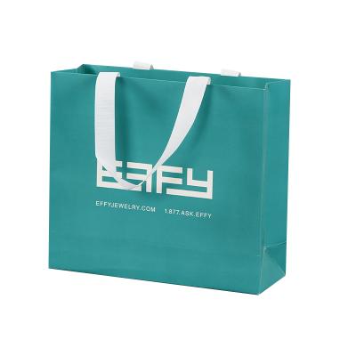 China Recycled Materials Manufacturer Customized White Cardboard Paper Bag Fashion Clothes Shopping Tote Bag for sale