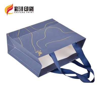 China 2021 New Logo Cotton Rope Handles Hot Foiled Stamping Black Matt Kraft Paper Bag With Gold Factory Disposable for sale