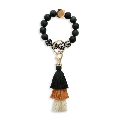 China New Leopard Print Rubber Edible Silicone Beads Tassel Wrist Key Chain Silicon Bracelet Female Keychain for sale