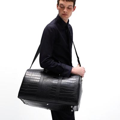 China Fashion logo custom black crocodile pu leather travel bags outdoor duffle luggage rolling bags for men for sale