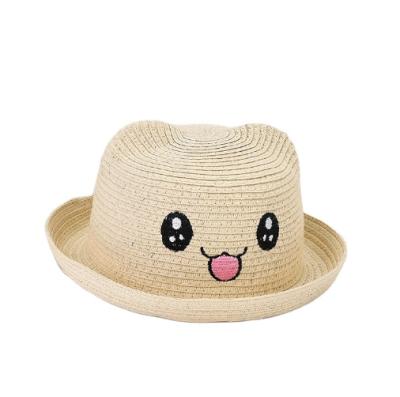 China Cheap Picture Wholesale Kids Cute Embroidery Smile Face Straw Hats for sale