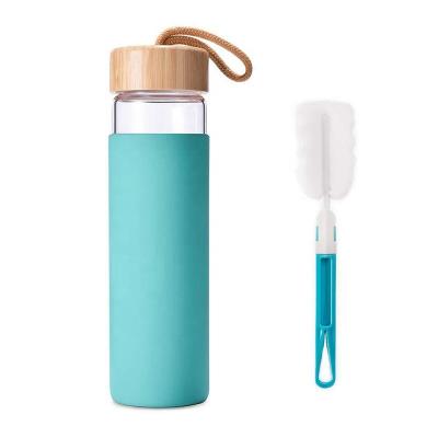 China Sleeve 550ml Minimalist Glass Water Bottle Silicone Bamboo Lid for sale