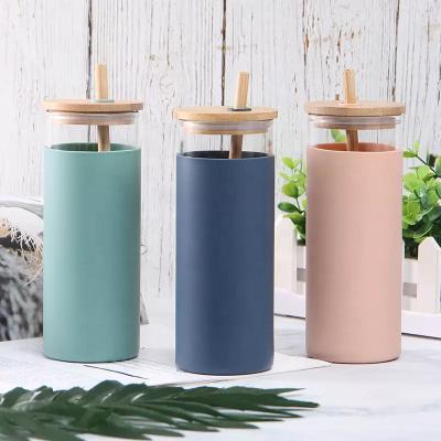 China Sustainable glass bottle water with bamboo straw and lid for sale