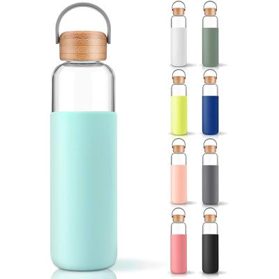 China Sustainable 20oz Gym Glass Water Bottle Sport Drinks Bottle With Bamboo Lid And Sleeve Portable For Travel Outdoor Activities for sale