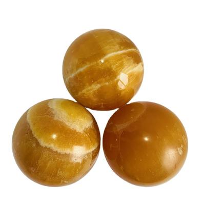 China Europe wholesale price high quality natural crystal home decoration orange calcite sphere for sale