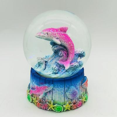 China Custom Animal Water Ball Souvenir Glass Resin Country Dolphin Wave Series Hotel and Resort Ocean Lighthouse Snow Globe With Glitter for sale